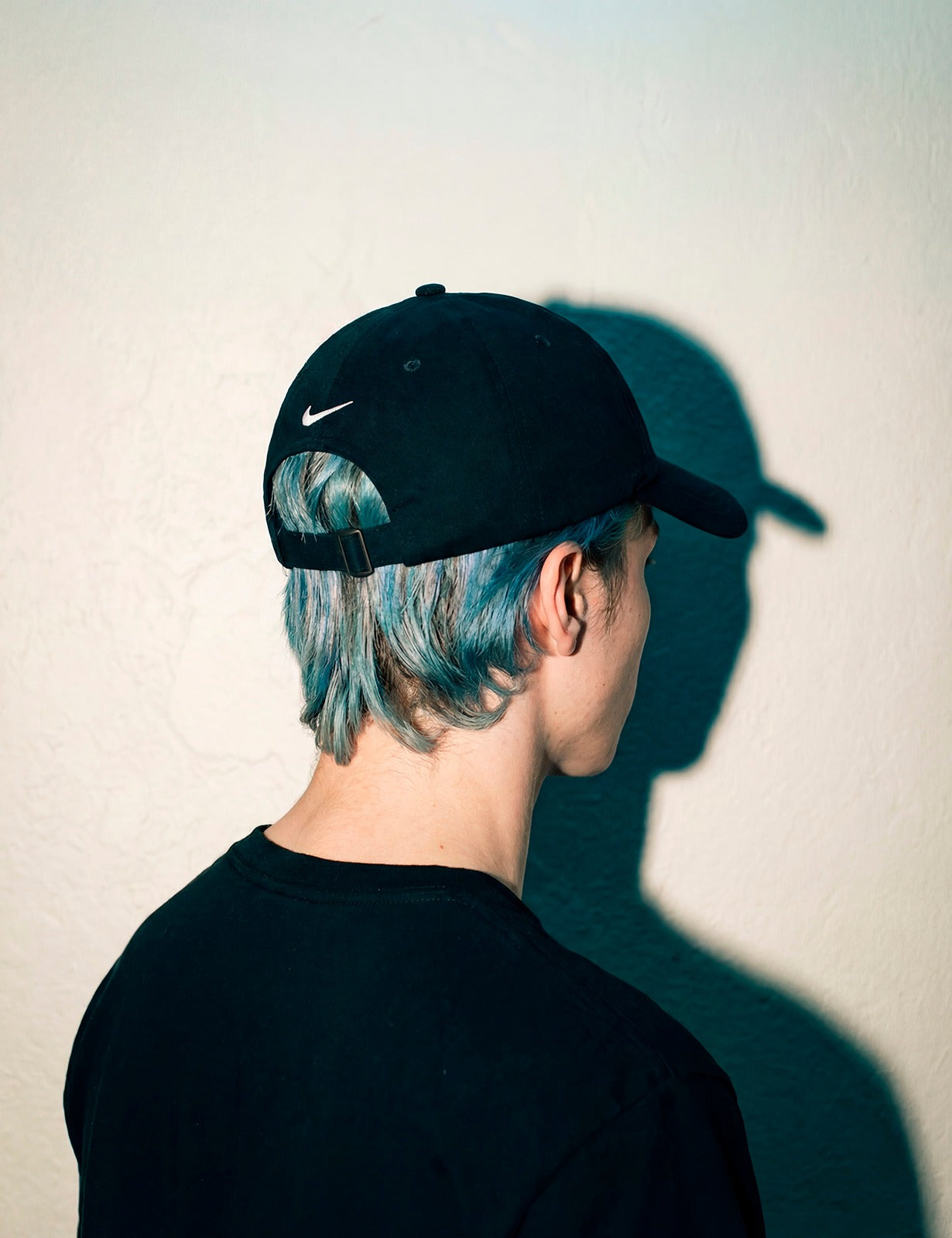 Back view of a black MORE ORANGE™ dad hat showing clean unstructured fit